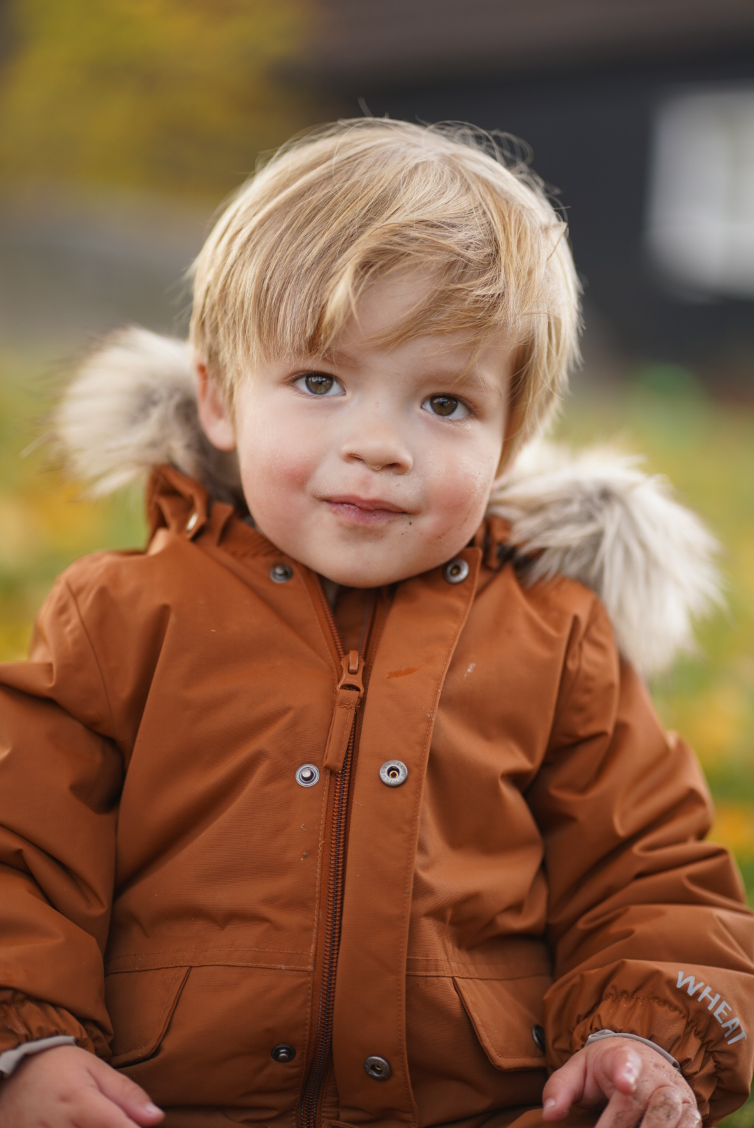 Noah in rust colored parka
